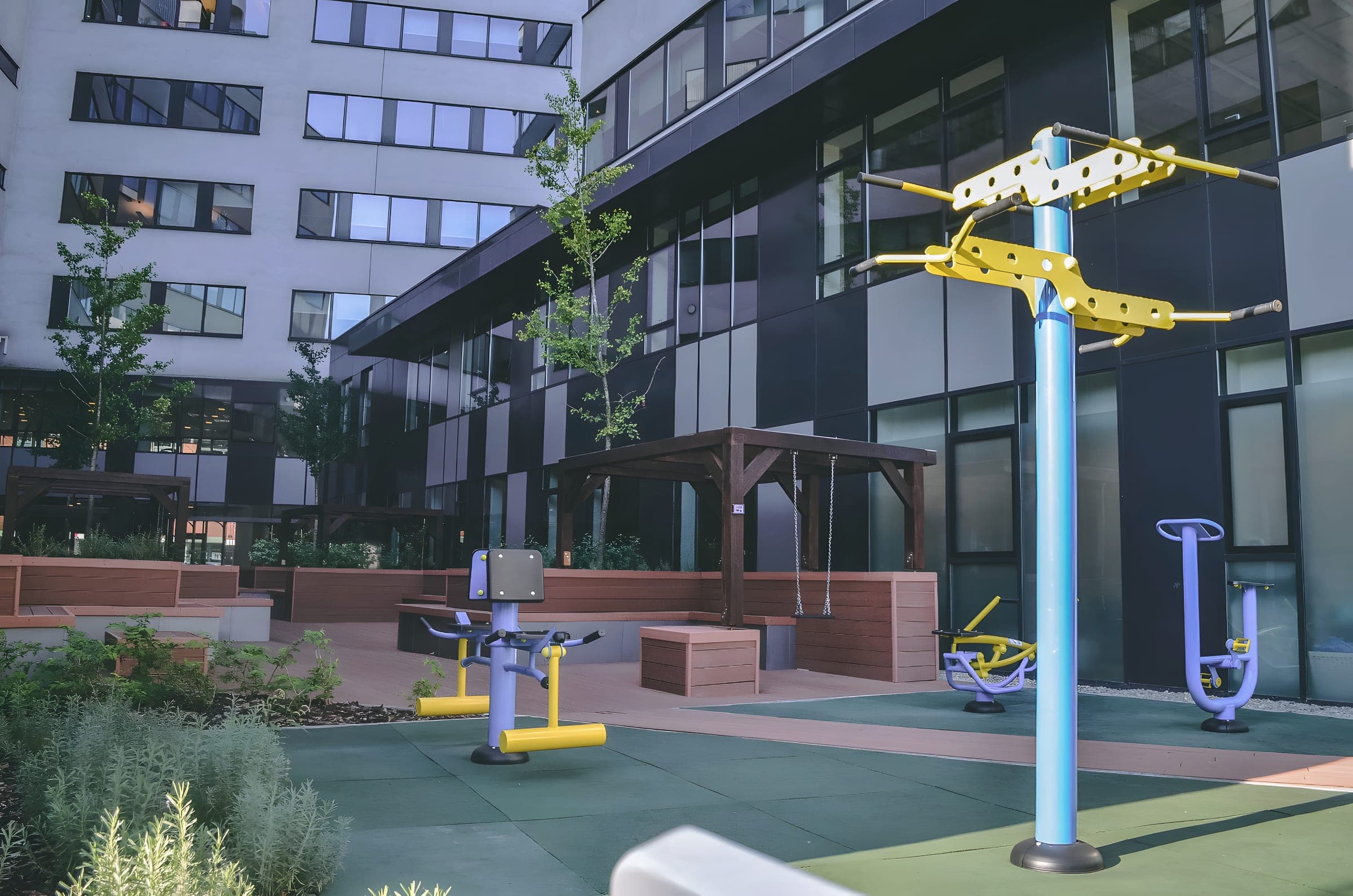 Outdoor gym equipment in the garden between the two wings