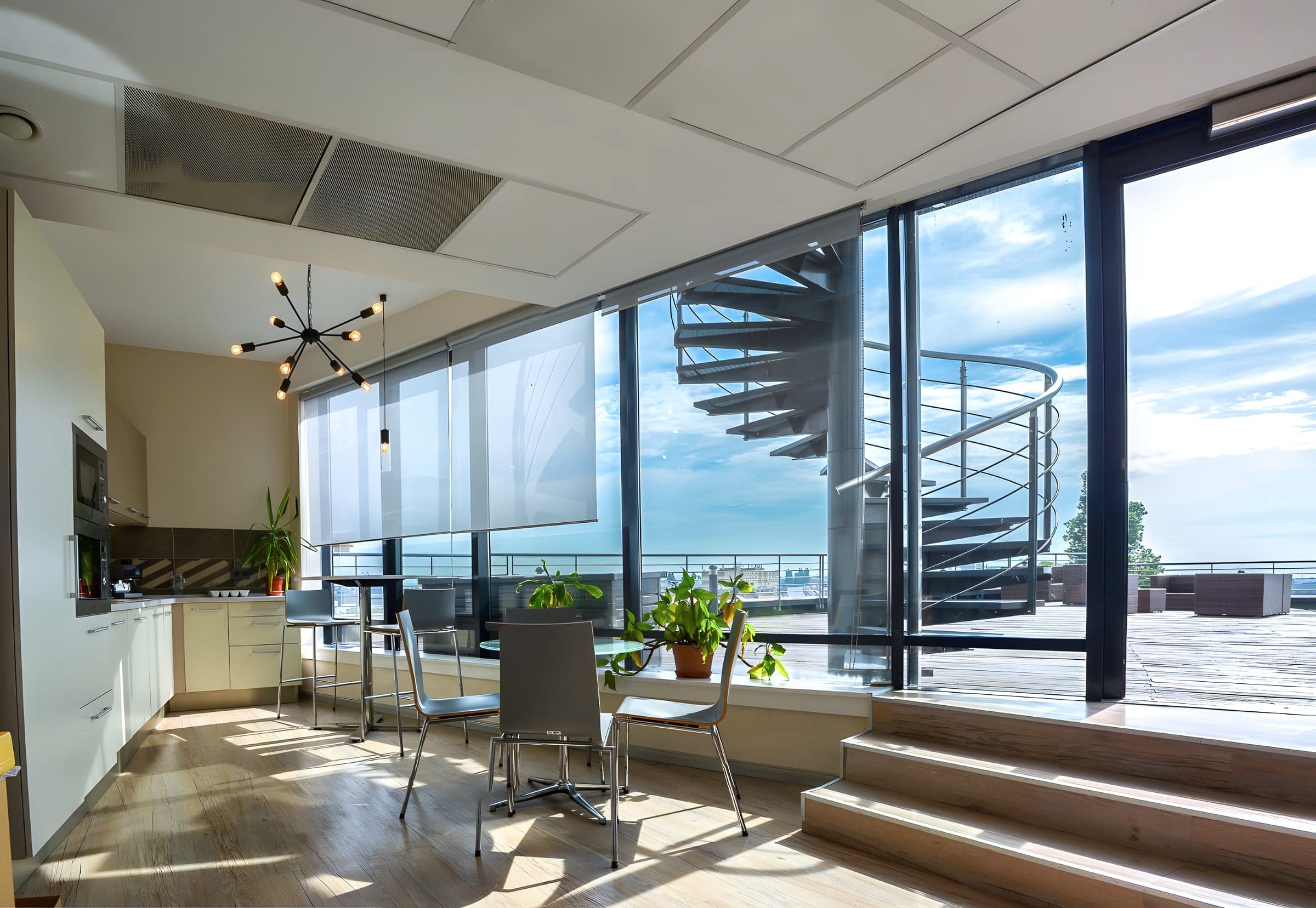 Top-floor kitchen with a spiral stair up to the private terrace